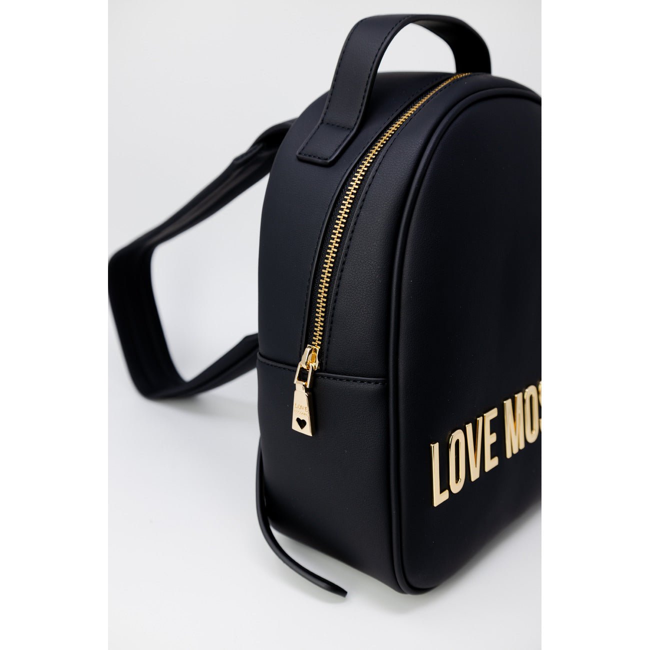 Close-up side view of Love Moschino black mini backpack with gold logo and zipper closure.
