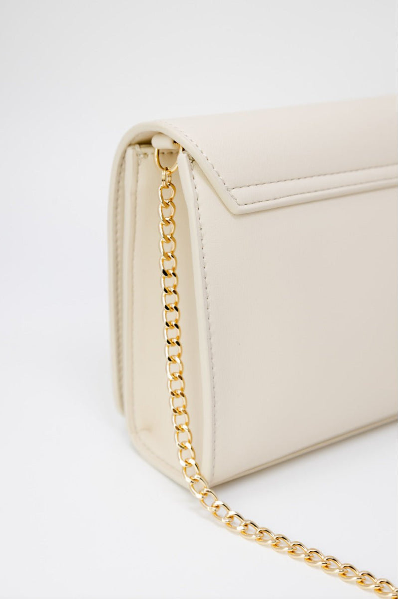 Love Moschino beige shoulder bag in faux leather with gold chain, clip closure, and bold logo detail. 